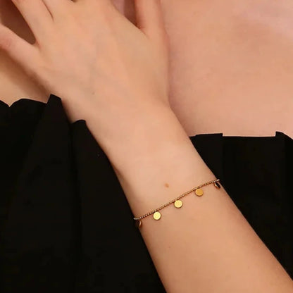 Bracelet doré à pampilles circulaires